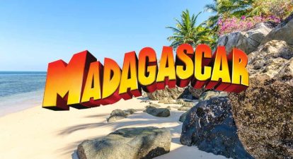 Title art for the animated movie, Madagascar, with blue sky, beach and palm trees.