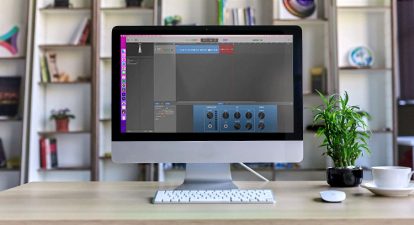 Mac display with GarageBand on the screen sitting on an office desk