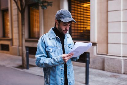 Actor reading script waking on the street.