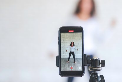 Young black woman created her dancing video content by smartphone camera to live streaming to social media application for view, like and share.