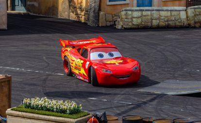 A picture of a decorated car as Lightning McQueen from the movie Cars.