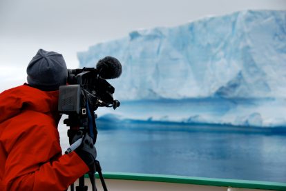 cameraman films an iceberg in antarctica