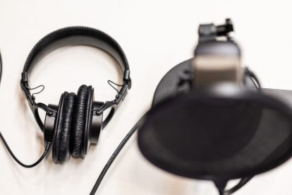 A photo of black headphones and a microphone.