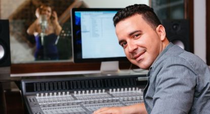 An audio engineer in front of a mixing console