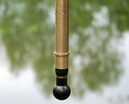 A photo of a hydrophone hovering above water.