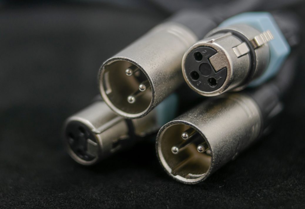 The metal ends of four XLR cables