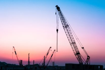 Construction site Work colorful background during sunset, Big crains and building maintenance works