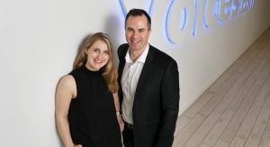 Stephanie and David Ciccarelli pose in front of the Voices.com sign in their 45,000 square foot office in London, Ontario, Canada