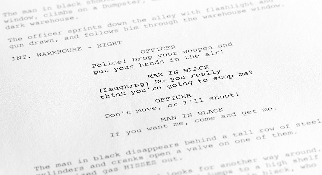 A close up of a script describes a scene between a police man and a robber