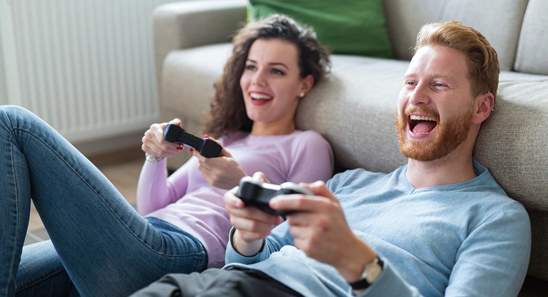 A millennial couple playing video games together