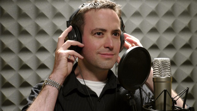 A photo of D'Arcy Smith at a microphone.