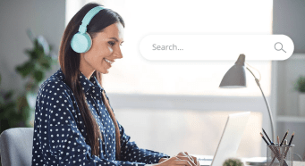 Person listening to audio on headphones while searching the internet.