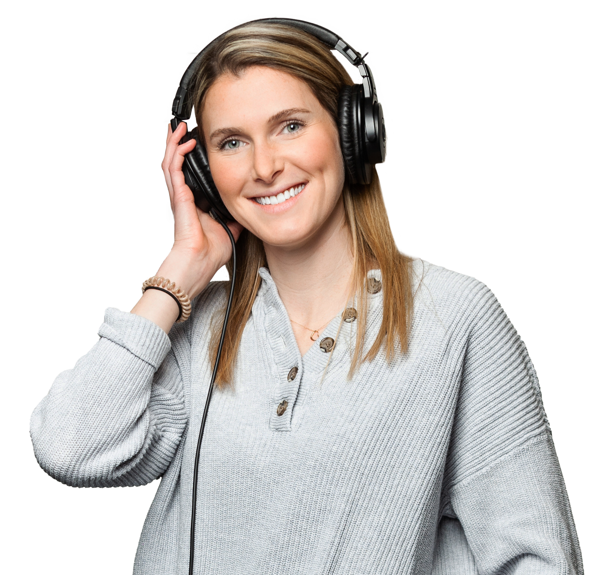 A female voice actor smiling and wearing headphones.